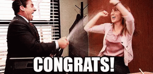 A gif from a tv show with two people celebrating and spraying champagne
